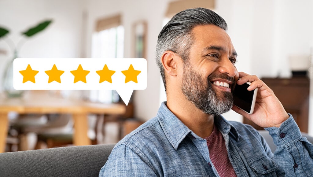 Man talking on phone while sitting on couch.